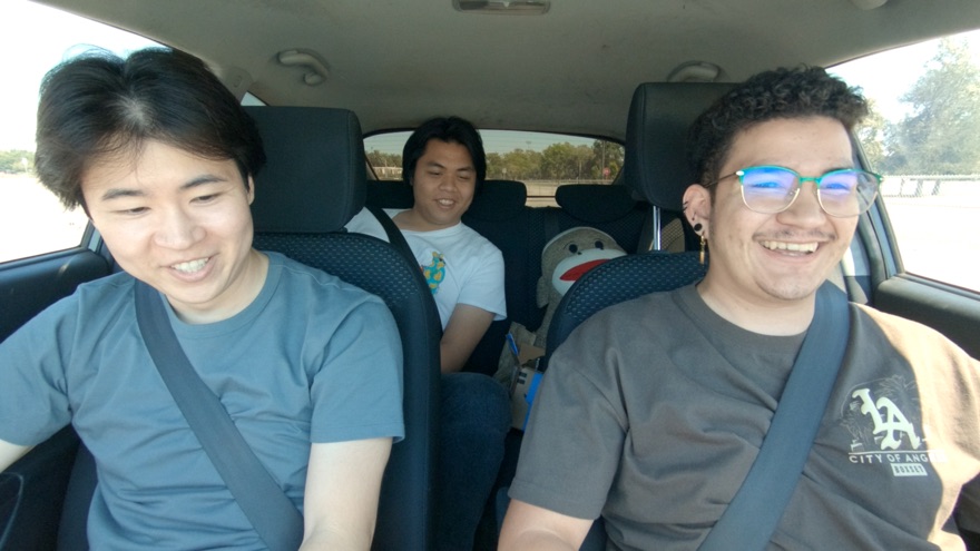 Yuji, a student, and the friend they brought along riding in the back seat
